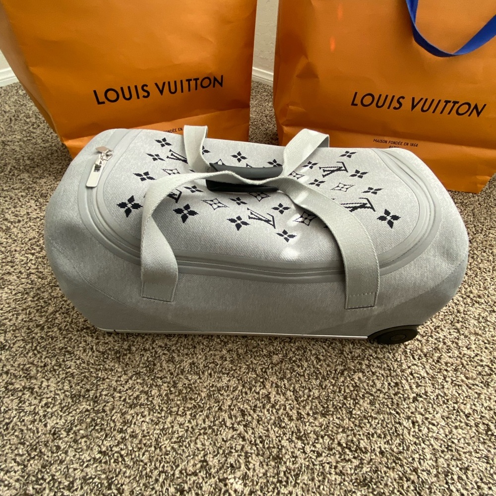 Grey Louis Vuitton carry on luggage